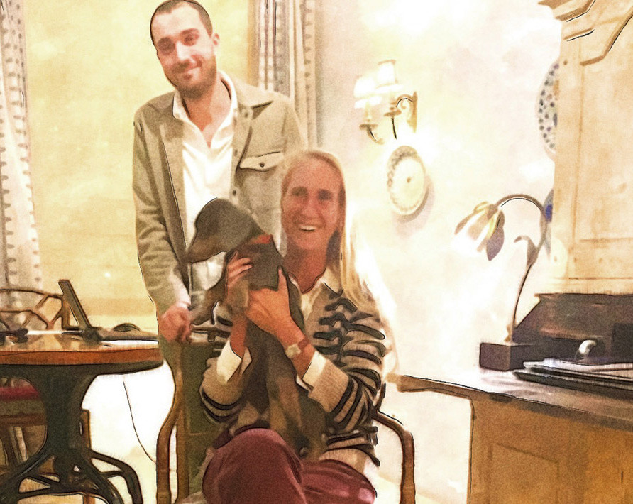 Christian Balle and Cristine Bedfor holding a dog inside a home.